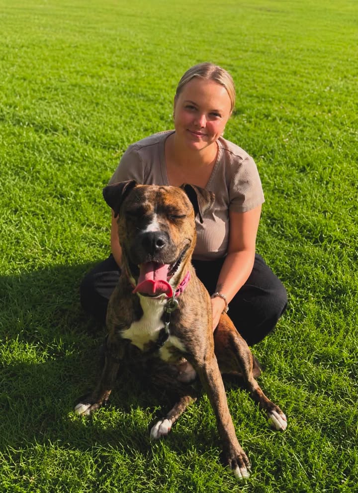 The owner of Mums Muddy Paws with a dog
